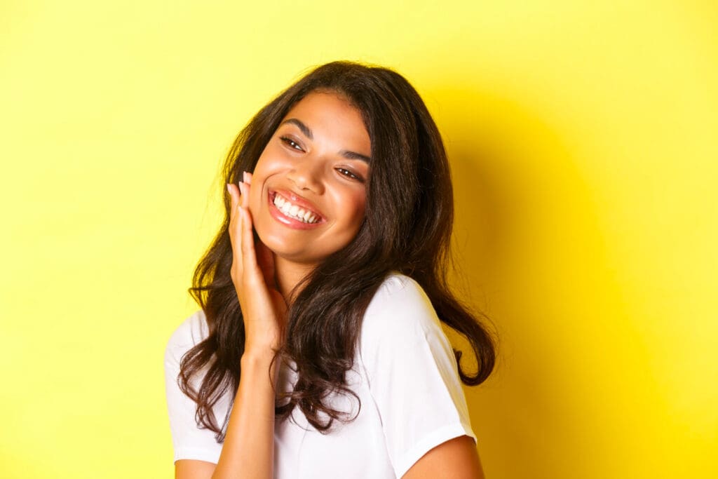 Confident woman with glowing skin after the procedure at Serenity Med Spa